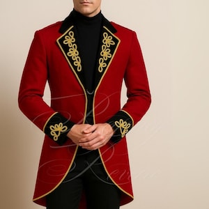 May include: A red formal jacket with black accents and gold embroidery. The jacket features a high collar and decorative floral patterns on the cuffs and lapels. The jacket is tailored with a long, fitted design.