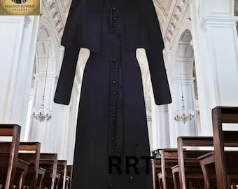 May include: A black clerical cassock with a matching cape and long sleeves. The cassock features a button-down front and a white collar. A cross pendant hangs from a black cord. The image includes the text "RRT".