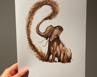 May include: A brown watercolor painting of an elephant with its trunk raised, spraying a brown cloud. The elephant is sitting down, with its tusks visible. The artwork is on a white paper.