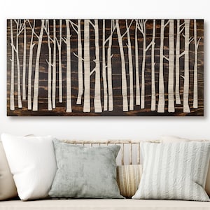 May include: A wooden wall art piece featuring a stylized design of a forest with white trees against a dark brown background.