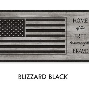 May include: A black and white doormat with a wood grain texture. The doormat features a stylized American flag with the text "HOME of the FREE because of the BRAVE" in black.