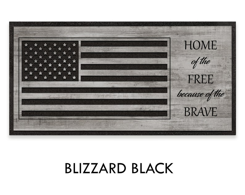 May include: A black and white doormat with a wood grain texture. The doormat features a stylized American flag with the text "HOME of the FREE because of the BRAVE" in black.