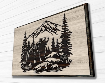 May include: A black bear silhouette standing on a rock in front of a mountain and pine trees, all cut out of a wooden panel with a light wood grain background.