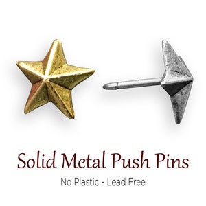 May include: Two solid metal push pins, one gold star shaped and one silver arrow shaped.  Solid Metal Push Pins. No Plastic - Lead Free.