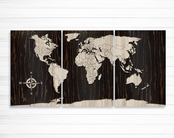 May include: A three-piece wooden world map wall art with a compass design. The map is carved into the wood and painted white. The background is a dark wood grain.