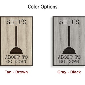 May include: Two wooden signs with the text "SHIT'S ABOUT TO GO DOWN" and a plunger graphic. The sign on the left is tan with brown text and the sign on the right is gray with black text.