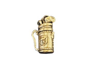 May include: A gold-colored golf bag charm with a golf club sticking out of the top.