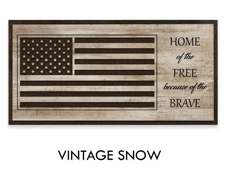 May include: A wooden sign with a distressed wood background and a black American flag design. The text "HOME of the FREE because of the BRAVE" is printed in black on the right side of the sign.