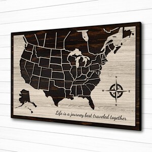 May include: A wooden map of the United States with a compass and the text "Life is a journey best traveled together".