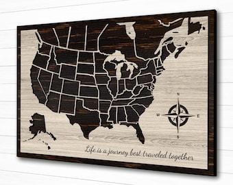 May include: A wooden map of the United States with a compass and the text "Life is a journey best traveled together".