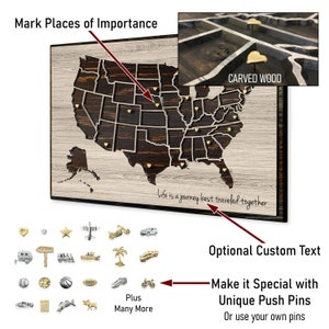 May include: A wooden map of the United States with a carved wood frame. The map is decorated with gold heart-shaped push pins. The text "Life is a journey best traveled together" is written on the bottom of the map. The image also shows a variety of decorative push pins, including a camper, a train, a palm tree, a motorcycle, and a basketball.