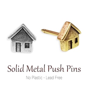 May include: Two solid metal push pins shaped like houses. One is silver and the other is gold. The text "Solid Metal Push Pins" and "No Plastic - Lead Free" is below the pins.