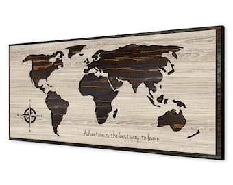 May include: A wooden world map with a compass and the text "Adventure is the best way to learn". The map is cut out of the wood and the background is a light wood color.