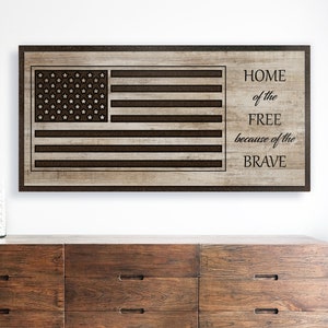May include: A wood sign with a brown American flag design and the text "HOME of the FREE because of the BRAVE".