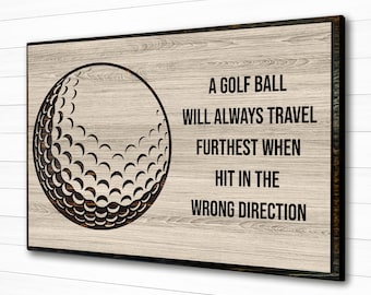 May include: A golf ball graphic with the text "A golf ball will always travel furthest when hit in the wrong direction". The graphic is on a wood background.
