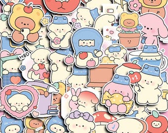May include: A selection of colourful stickers showcasing adorable cartoon characters in diverse poses. The stickers feature characters dressed as bears, apples, and mushrooms, with hearts, flowers, and other decorative elements. The stickers are on a pink background.
