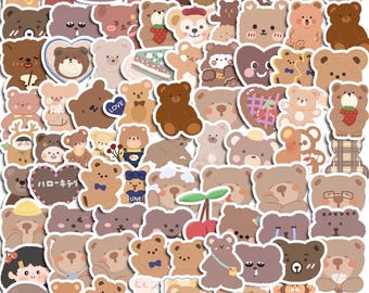 May include: A selection of bear-themed stickers in shades of brown, beige, and white. The stickers depict different bear designs, some with accessories like hats and bows, and some with text. The stickers are in various shapes and sizes.