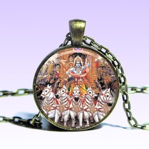 May include: A round glass pendant necklace with a bronze chain. The pendant features a colourful image of a Hindu deity riding a chariot pulled by white horses.