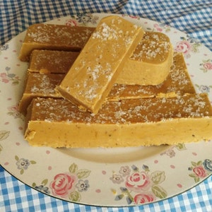 May include: A plate of homemade fudge bars with a light brown colour and a sprinkle of salt on top.