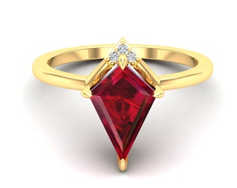 May include: A gold ring with a large, red, triangular gemstone and three smaller, white gemstones. The ring is set in a gold band.