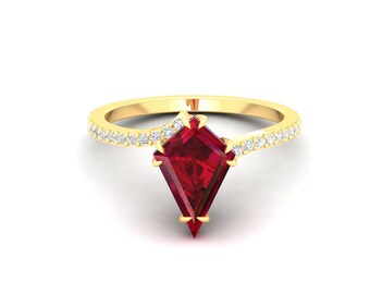 May include: A gold ring with a red gemstone and a band of small diamonds.