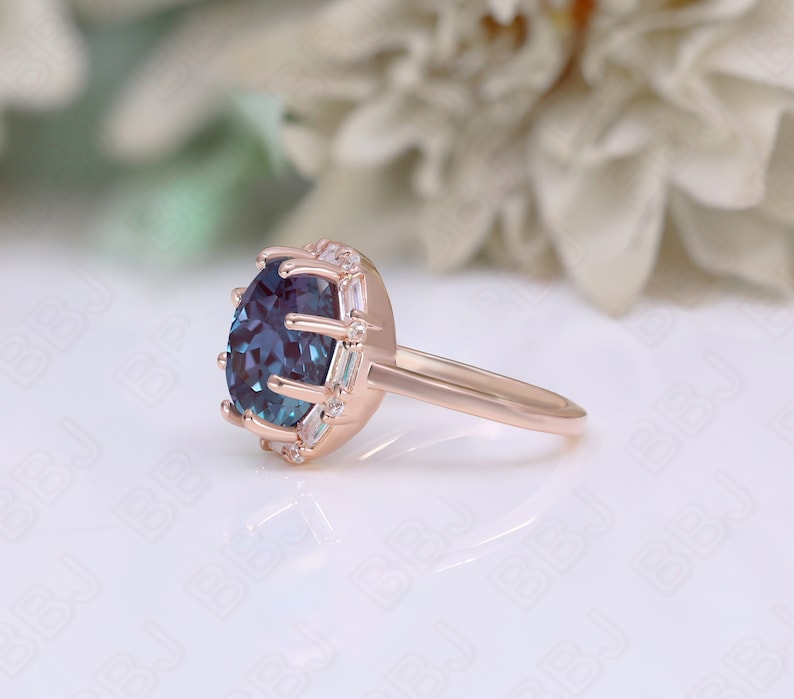 May include: A rose gold engagement ring with a large blue gemstone surrounded by a halo of smaller white gemstones.