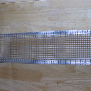 May include: A silver wire mesh rectangular basket with a fine wire grid pattern.