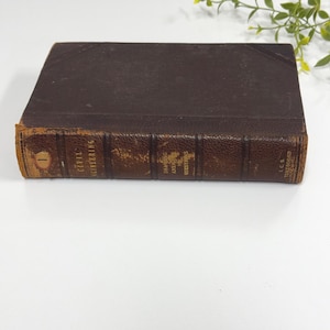 May include: A vintage brown leather-bound book titled "Civil Engineering" with gold lettering. The book has a worn appearance, with visible wear on the edges and spine. The book is a textbook.