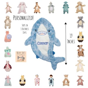 May include: A plush blue shark with the name "Conner" embroidered on it, measuring 19 inches. The image also features various stuffed animal designs, including a bunny, a sloth, and a ladybug.