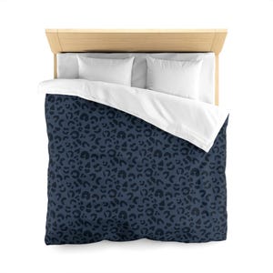 May include: A navy blue duvet cover with a dark blue leopard print pattern.