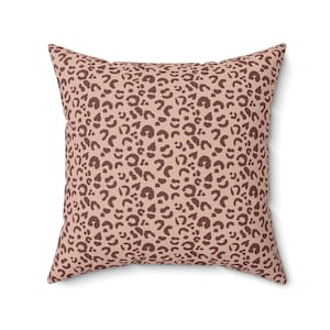May include: A pink throw pillow with a brown leopard print pattern.