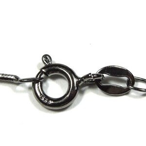 May include: A silver chain necklace with a lobster clasp closure.