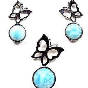 May include: A set of three silver butterfly pendant earrings with blue and white gemstone drops.