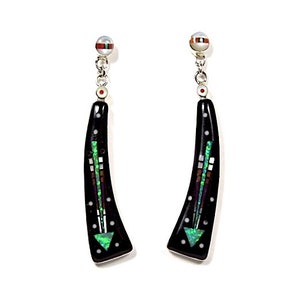 May include: A pair of black dangle earrings with a geometric design made of green, white, and brown inlay. The earrings are made of silver and have a pearl-like bead at the top.