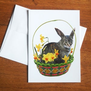 Carte de lapin chat dans un panier de jonquilles, carte de fleurs de printemps de chat