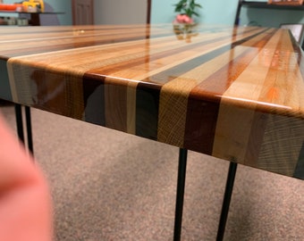 Table Glamour custom hardwood butcher block table with hair pin legs.  Laser Engraving and epoxy avail.  Call for more details.