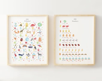 May include: Two framed educational posters for children. The left poster features a colorful alphabet with illustrations for each letter. The right poster features numbers 1-10 with illustrations for each number. Both posters have a white background with a light wood frame.