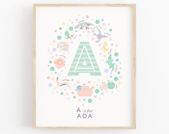 May include: A framed art print featuring the letter "A" in a light green and white striped design. The letter is surrounded by colorful illustrations of objects and animals, including an alligator, apple, and antelope. The text "A is for ADA" is at the bottom.