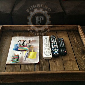 May include: A wooden tray with a magazine, two remotes, and the text "Thirty-one" on the magazine.