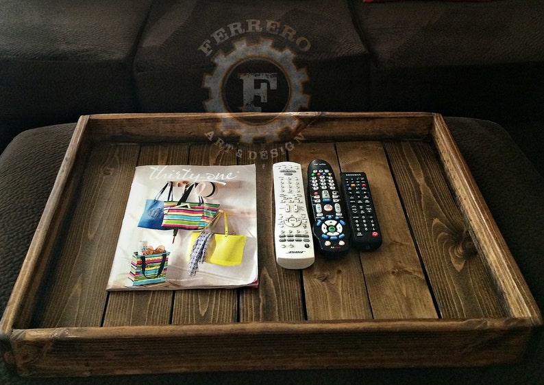 May include: A wooden tray with a magazine, two remotes, and the text "Thirty-one" on the magazine.
