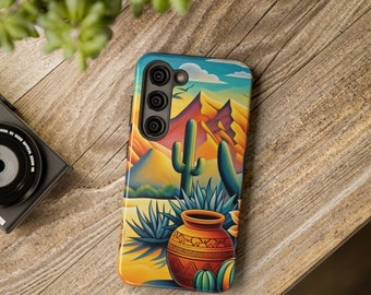 May include: A colourful phone case featuring a desert landscape with a cactus, a clay pot, and a mountain range. The case has a cut-out for a triple camera lens.