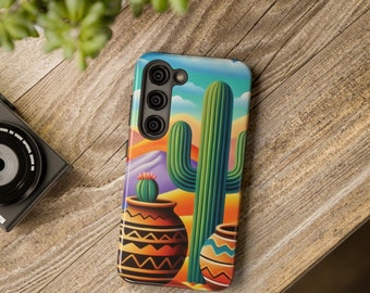 May include: A phone case featuring a colourful illustration of a cactus in a desert landscape. The case has a camera cutout with three lenses.