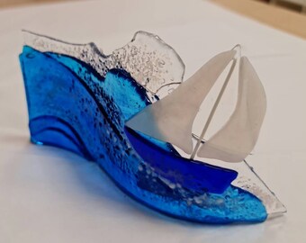 Blue fused-glass wave with yacht boat
