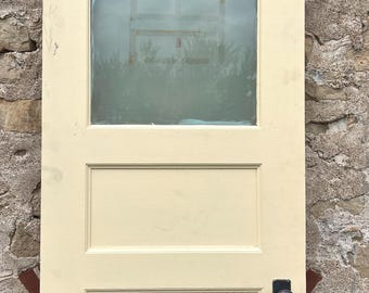 May include: A vintage, off-white, four-panel interior door with a frosted glass window and a black door knob.