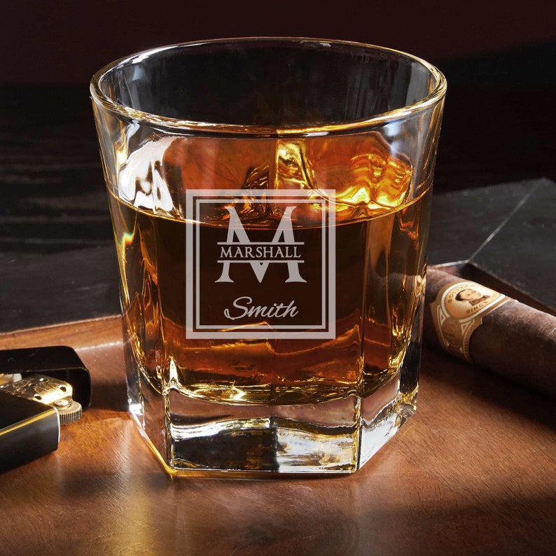 Close-up of the engraved whiskey glass with a personalized design.