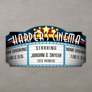 Close-up of home theater sign with vivid colors and a natural wood grain finish.