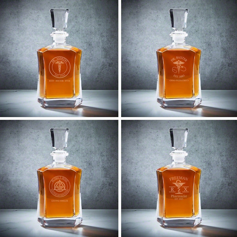 May include: Four clear glass decanters with stoppers. Each decanter has a different medical-themed design with a name and profession engraved on the front. The designs include a doctor, a pediatrician, a dentist, and a pharmacist.
