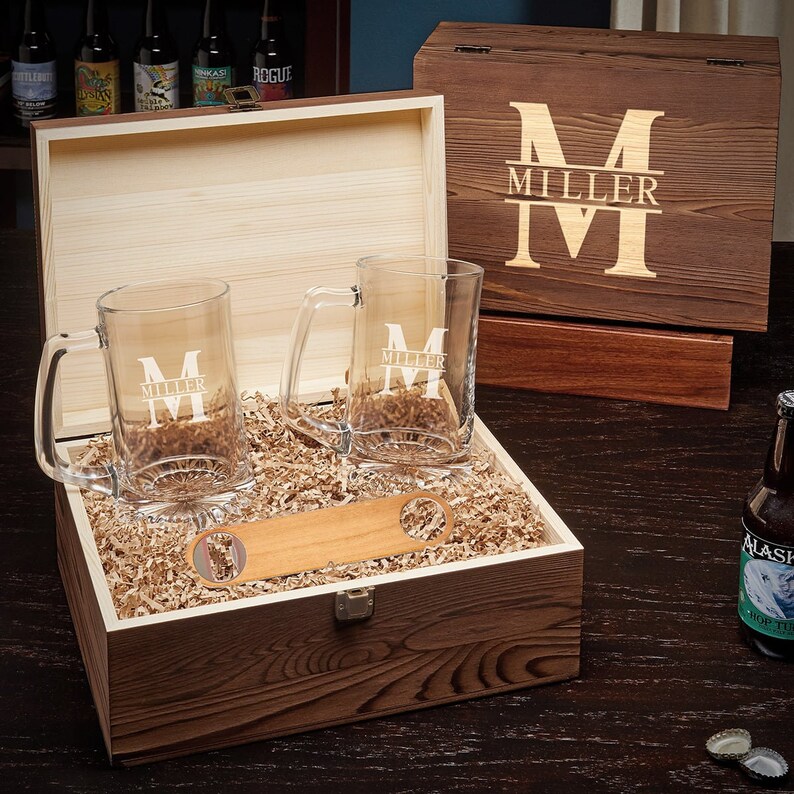Two engraved beer glasses and a bottle opener inside the personalized wooden box.