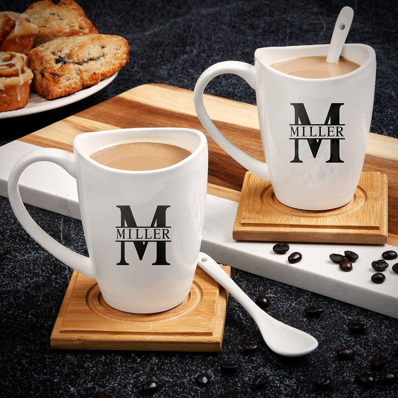 Two custom coffee mugs with two mixing spoons and two coasters.