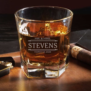 Close-up of the engraved whiskey glass with a personalized design.